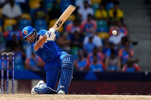 Gulbadin Naib plays a shot against India